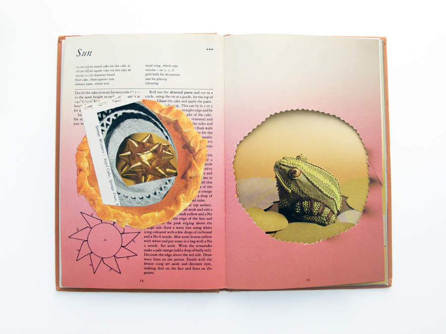 A naive collage on a double page spread of a recipe book, featuring a golden ribbon rosette, an icing frog and some pastry.