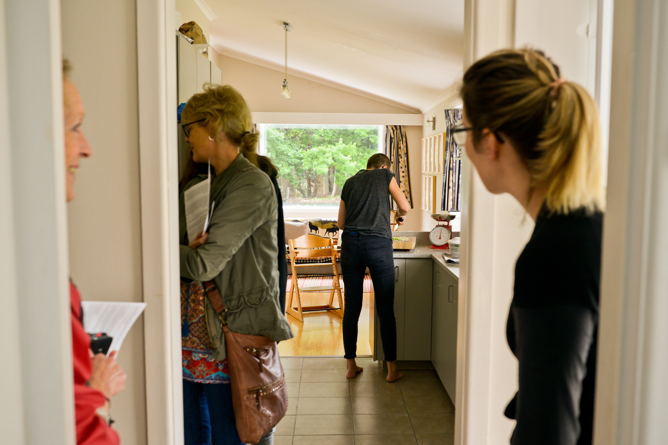 Preparing lunch while guests look on.